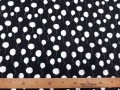 Een zwarte tricot met witte ballonnetjes.Oekotex stof 95% katoen/5% elastan 1.50 mtr.breed