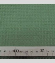 Legergroen grof wafeldoek. Het blokje is ongeveer 7 x 7 mm.  100% katoen  1.47 mtr. breed  230 gr./M2
