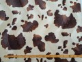 Een bontachtige velboa bruine koeien print. Naar 2 kanten, in golf, geschoren. Voor kleding, decoratie. 100%pes 1.60 mtr.br.