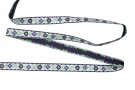 Lila sierband met paarse bloemen.  Ongeveer 12 mm breed  Een stuk van 8 meter en een stuk van 4.5 meter op voorraad
