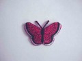 Een opstrijkbare vlinder applicatie van 5 x 3.5 cm. Donkerpink glitter