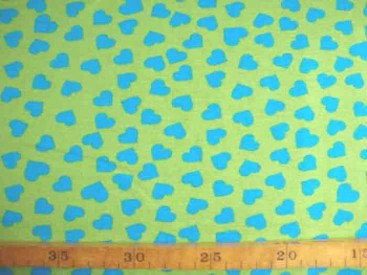 Een limekleurige tricot met aquakleurige hartjes. Rekt zowel in de breedte als in de lengte. 95%co/5%el. 1,50 mtr. br. 200gr/m2 