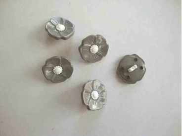 Een grijs/witte kunststof bloemknoop met een doorsnee van 15 mm.