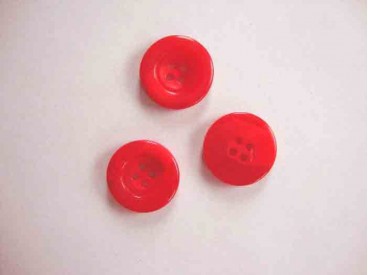 Een kunststof mantelknoop doorschijnend rood met een doorsnee van 25 mm.