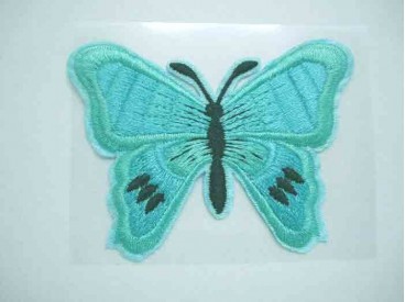 Een mint kleurige vlinder applicatie van 7 x 6 cm.  Om te plakken of te strijken, 2 in 1.